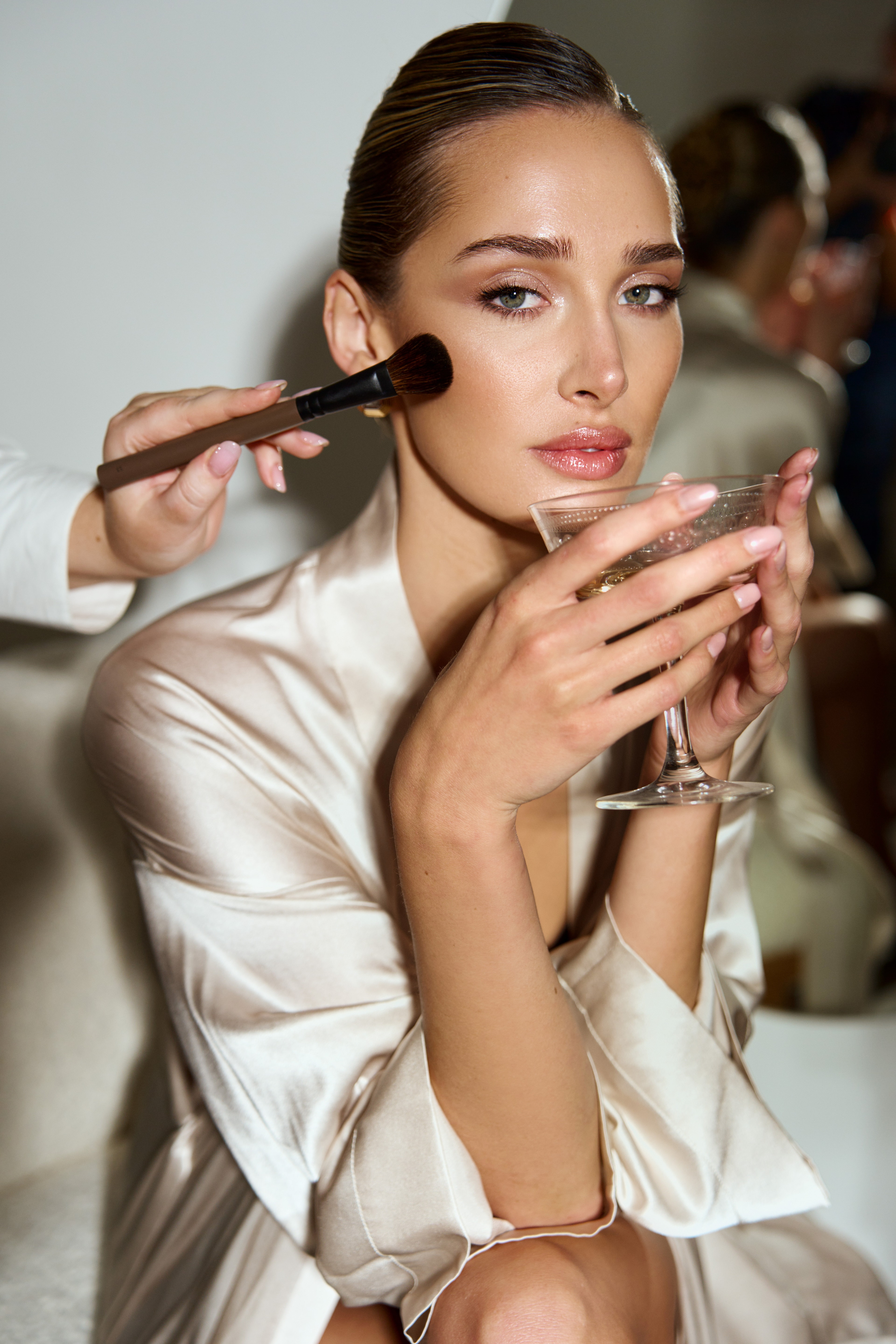 Finishing touches, robe and a glass in hand