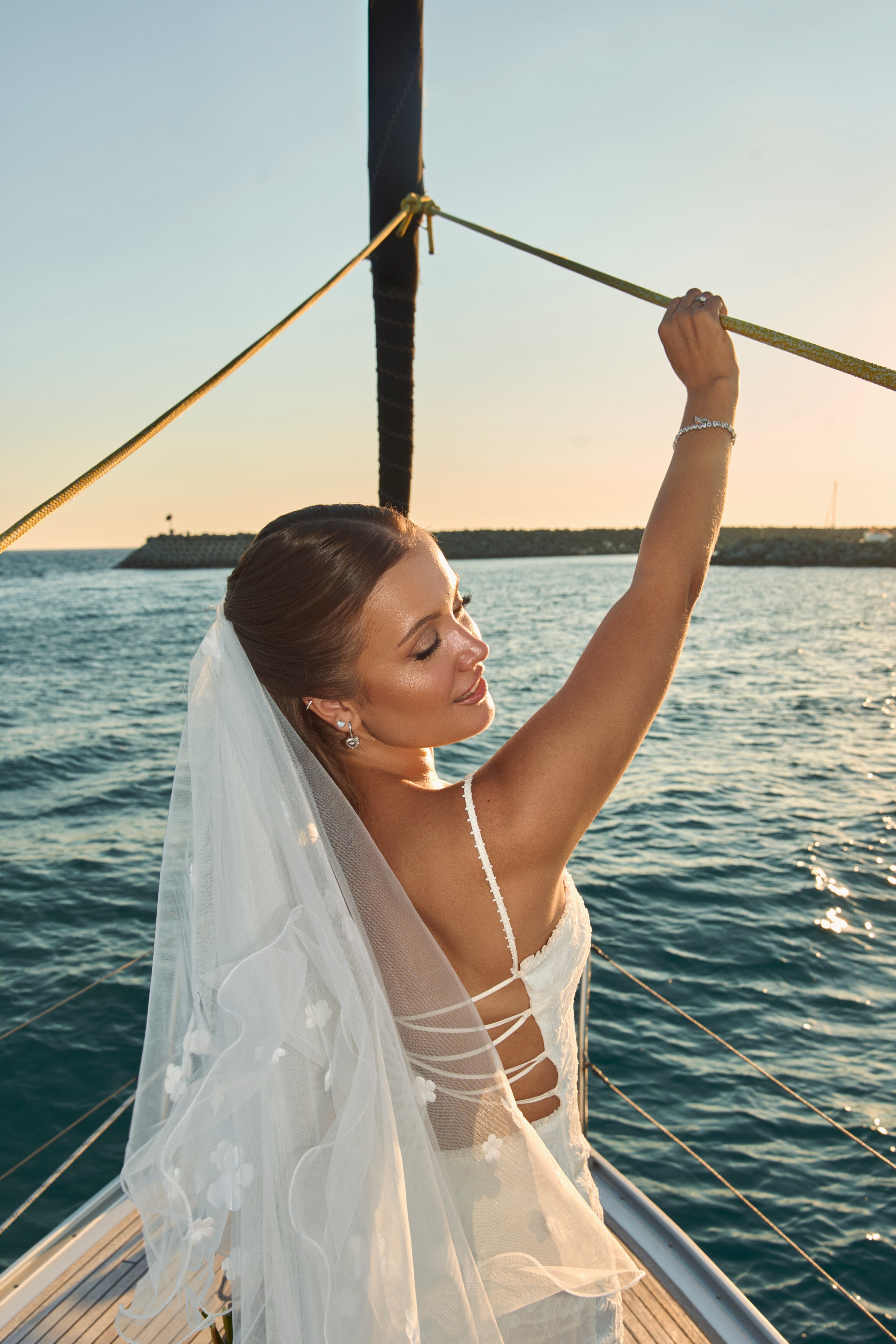 Bride on a sailboat at sunset